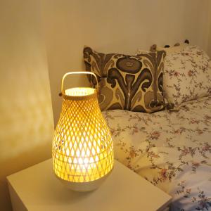 a yellow lamp sitting on a table next to a bed at toronto midtown luxury double bed in Toronto