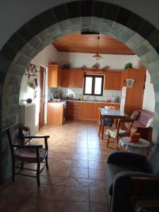 a kitchen and a living room with a table and chairs at house FYNTIKAKH - SKALA in Anopoli Sfakion