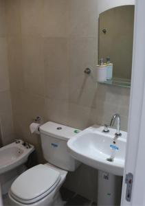 ein Badezimmer mit einem weißen WC und einem Waschbecken in der Unterkunft Departamentos Ciudad de Nieva in San Salvador de Jujuy