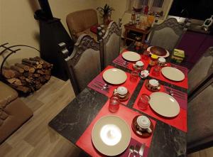 un tavolo con piatti bianchi e tovaglioli rossi di La Stria del Re a Rino