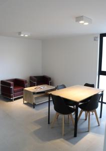 a room with a table and chairs and a couch at Departamentos Ciudad de Nieva in San Salvador de Jujuy