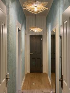 a hallway with a black door and a chandelier at H-36 RESIDENCE 0.1 in Koblenz