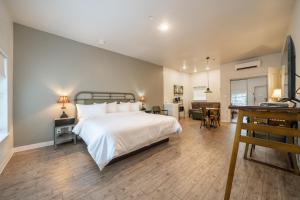 a bedroom with a large bed and a living room at Best Court in Hot Springs