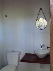 a bathroom with a toilet and a sink and a window at Cabana das Mandalas in Itacaré +25 photos