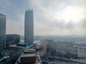 a view of a tall building in a city at SAG Panorama Apartment 3 rooms 19th floor Great view Free parking in Bratislava +25 photos