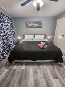 a bedroom with a large bed with a black blanket at Blue Shark *B2* @ Bellaire 1BR King Apartment Near Medical Center in Houston