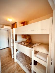a childs bunk bed with a teddy bear on the bottom bunk at Appart 5pers joue du loup pied de pistes vue top in La Joue du Loup