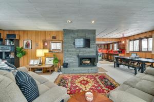 a living room with a fireplace and a tv at Fresh and Retro Chalet Fire Pit, 4 Min to Gore Mtn in North Creek