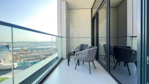 balcón con sillas y vistas a la ciudad en Business Bay - Near Metro Station - 1 Bedroom Apartments - Zada Tower - Keyrock HH en Dubái