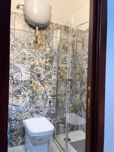 a bathroom with a toilet and a shower at House Caracciolo in Naples