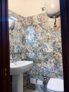 a bathroom with a toilet and a sink at House Caracciolo by Loveinthetravel in Naples