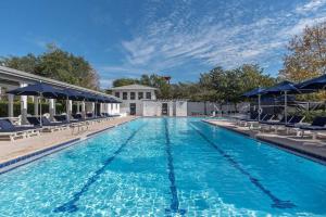 a large swimming pool with chairs and umbrellas at Just for Fun 2 in Santa Rosa Beach