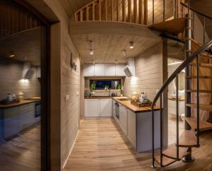 an open kitchen with a spiral staircase in a house at Satori Lounge in Lublin