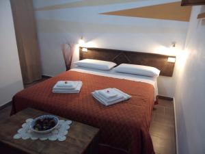 a hotel room with a bed with a bowl of fruit on it at Bed And Breakfasts LA CASETTA in Terranova di Pollino