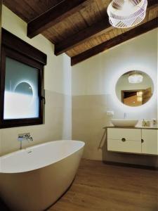 a bathroom with a large tub and a sink at Casa Rural: La Tarara 