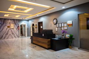 a hair salon with a reception desk and a clock at Tara One Apartment By Alin in Riyadh