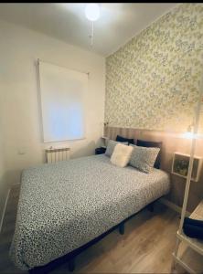 a bedroom with a bed and a wall with flowers at Madrid Citymad Six in Madrid +48 photos