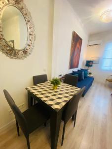 a dining room table with chairs and a mirror at Madrid Citymad Six in Madrid