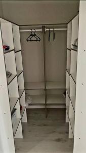 an empty walk in closet with white cabinets at Cómodo, tranquilo y acogedor. in Caldera