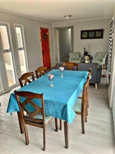 a dining room table with two wine glasses on it at Cómodo, tranquilo y acogedor. in Caldera +10 photos