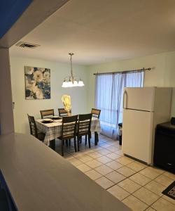 a kitchen and dining room with a table and a refrigerator at Nice 2 Bedroom 1 Bath Condo Across From Broadway in Myrtle Beach