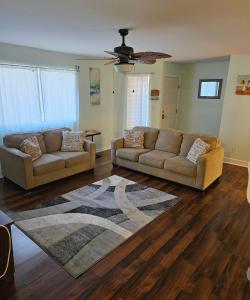 a living room with two couches and a rug at Nice 2 Bedroom 1 Bath Condo Across From Broadway in Myrtle Beach