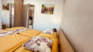 two beds sitting next to each other in a room at Eugen Apartmán in Veľký Meder