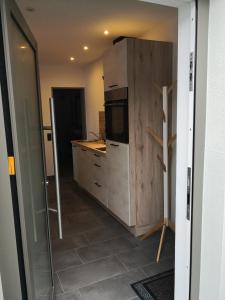 a kitchen with a refrigerator and a counter top at Apartment in Nonnweiler-Otzenhausen in Nonnweiler