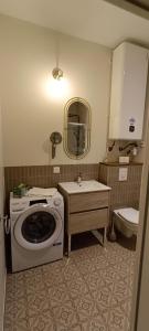 a bathroom with a washing machine and a sink at Antares - SILS --- 2 chambres séparées en mezzanine in Caen