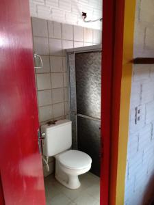 a bathroom with a white toilet in a room at CASA EM PORTO in Porto De Galinhas