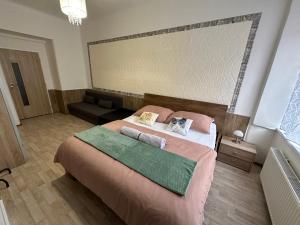 a bedroom with a large bed and a couch at O2 Arena - Honza Apartment Praha in Prague