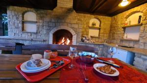 a table with plates of food and a fireplace at Villa Harta in Vrchlabí