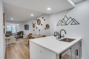 a kitchen with a sink and a living room at Remodeled Vail Condo with Hot Tub Access! in Vail