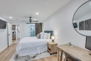 a white bedroom with a bed and a mirror at Remodeled Vail Condo with Hot Tub Access! in Vail