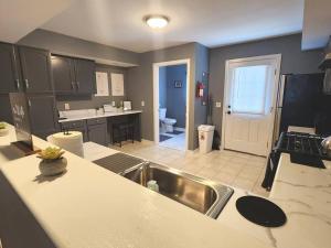 a kitchen with a sink and a counter top at The Grey Escape-Close to Beach Waterpark & Casinos in Atlantic City