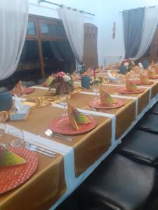 a row of tables with plates of food on them at Hanul Anitei La paducel 