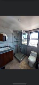 ein Bad mit einer Dusche, einem WC und einem Waschbecken in der Unterkunft HABITARE in La Paz