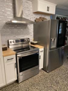 a kitchen with a stainless steel stove and refrigerator at Coombs Manor on the Mountain in Ripley