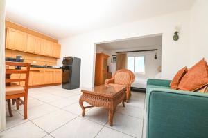 a living room with a couch and a table at E Solo Aruba Apartments in Oranjestad