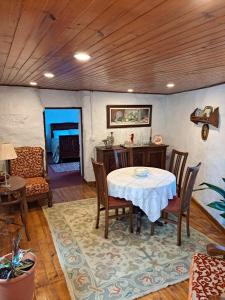 a dining room with a table and chairs in a room at Quinta da Lage Agroturismo e Enoturismo in Celorico de Basto