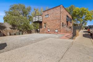 a brick building with a balcony on top of it at Astonishing Flagstaff Flat with AC and Jacuzzi! in Flagstaff