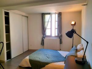 a bedroom with a bed and a window at Studio au coeur de Montpellier in Montpellier