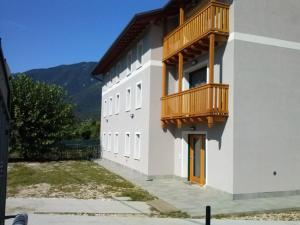 a building with two balconies on the side of it at Albergo Diffuso Polcenigo Casa Rigo in Polcenigo