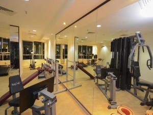 a gym with a mirror and some tread machines at Beautiful Bedroom in Al Barsha Near Mashreq Metro in Dubai