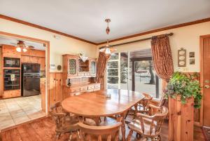 a kitchen with a wooden table and chairs at Relax in Frontier Retreat - Bordering Forest Service! in Flagstaff