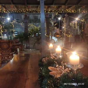 ein Zimmer mit Kerzen, Weihnachtsbäumen und Lichtern in der Unterkunft Vila Mariss in Korçë