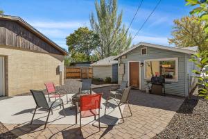 a patio with chairs and a table and a building at Captivating Downtown Greenlaw Getaway to the Mountains with AC! in Flagstaff