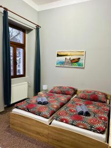 a bed with two pillows on it in a room at Thermal Apartments in Teplice