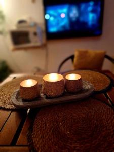 two candles sitting on a tray on a table at Cabane chez sam et gael in Charix