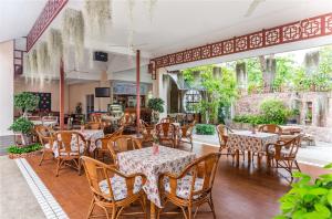 a restaurant with tables and chairs in a room at Eastern Grand Palace in Pattaya South
